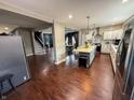 Bright open kitchen featuring white cabinets, stainless steel appliances, and a center island with stools at 201 N Tacoma Ave, Indianapolis, IN 46201