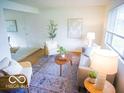 Bright living room featuring stylish decor, ample natural light, and cozy seating at 21 Roderick Ct, Beech Grove, IN 46107