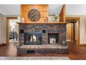 Living room fireplace with brick surround, wooden mantle, and decorative clock at 2411 N County Road 500 W, Muncie, IN 47304