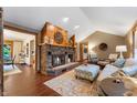 Cozy living room featuring brick fireplace, vaulted ceilings and hardwood floors at 2411 N County Road 500 W, Muncie, IN 47304