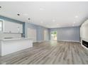 Open-concept living room featuring wood floors and recessed lighting at 2429 N Centennial St, Indianapolis, IN 46222