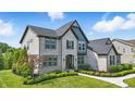 Attractive two-story home with brick and siding, complemented by lush landscaping at 2485 Alexandra Dr, Carmel, IN 46074