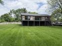 Charming home with a black foundation, and wooden deck overlooking a lush green yard at 258 Riverwood Dr, Noblesville, IN 46062