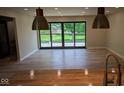 Bright open room with hardwood floors and deck access via sliding glass doors at 258 Riverwood Dr, Noblesville, IN 46062