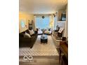 Inviting living room with a large window, fireplace, and cozy seating area at 2637 Grand Fir Dr, Greenwood, IN 46143