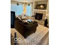 Comfortable living space featuring a fireplace, large windows, and stylish furnishings at 2637 Grand Fir Dr, Greenwood, IN 46143
