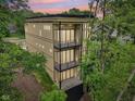 Modern home boasts balconies on each level with tree views at 2841 Tropical Dr, Indianapolis, IN 46205