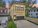 Beautiful three-story house with a balcony, gray garage door, and modern design at 2841 Tropical Dr, Indianapolis, IN 46205