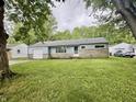 A well-maintained single-story home with blue siding and a lush green lawn in a serene neighborhood at 3325 Canaday Dr, Anderson, IN 46013