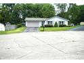 A single story home with a driveway and well maintained lawn and landscaping at 3612 Carolee Ct, Indianapolis, IN 46227