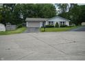 A single story home with a driveway and well maintained lawn and landscaping at 3612 Carolee Ct, Indianapolis, IN 46227