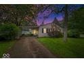 Single-story home with driveway and carport nestled on a well-maintained lawn with mature landscaping at 3801 N Vernon Dr, Muncie, IN 47304