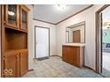 Inviting entryway featuring tile floors, built-in cabinets, and a mirror, enhancing the space's functionality at 4244 Asbury St, Indianapolis, IN 46227