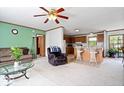 Cozy living room with plush carpet, comfortable seating, and an adjacent kitchen for easy entertaining at 4244 Asbury St, Indianapolis, IN 46227