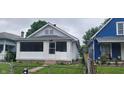 Quaint home with a small front porch, painted in neutral tones, set in a cozy neighborhood at 427 N Alton Ave, Indianapolis, IN 46222