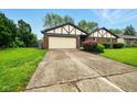 Exterior shot of a brick home with a large front yard and driveway at 4701 Candy Spots Dr, Indianapolis, IN 46237