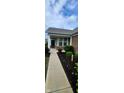 Inviting front porch with brick accents, lush landscaping, and a well-lit walkway leading to the entrance at 4960 Silverbell Dr, Plainfield, IN 46168