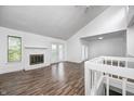 Bright living room with fireplace, vaulted ceilings, and access to a balcony at 5097 Vantage Point Rd # B 2, Avon, IN 46123