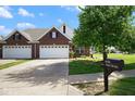 Lovely home with a two-car garage, mailbox, and pristine front yard in a friendly neighborhood at 6105 Franklin Villas Way, Indianapolis, IN 46237