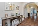 Foyer features hardwood floors, stylish mirror and view of arched hallway at 6337 Ederline Ln, Noblesville, IN 46062