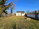 View of backyard with grass, wooden fence, and small patio at 640 S Sycamore St, Martinsville, IN 46151