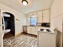 Well-lit kitchen with white cabinets and appliances, perfect for easy meal prep at 640 S Sycamore St, Martinsville, IN 46151
