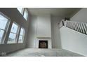 Bright living room with a fireplace and large windows, enhancing the feeling of spaciousness and grandeur at 6462 Stone Side Dr, Plainfield, IN 46168