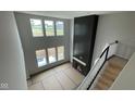 Open living room with a fireplace, large windows, and plenty of natural light showcases a cozy and modern space at 6462 Stone Side Dr, Plainfield, IN 46168