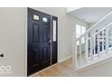 Welcoming front door with sidelight and transom window leads into a bright foyer with staircase at 65 Millet Ct, Danville, IN 46122