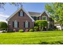 Charming brick two-story home with lush green lawn and well-maintained landscaping at 6649 Braemar S Ave, Noblesville, IN 46062