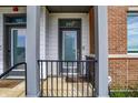 Charming apartment entrance with a gray door, columns, and brick accents at 727 N Illinois St # 202, Indianapolis, IN 46204
