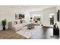 Staged living room featuring a plush sectional sofa and modern decor at 727 N Illinois St # 202, Indianapolis, IN 46204