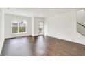 Bright, open-concept living room with hardwood floors and natural light at 727 N Illinois St # 202, Indianapolis, IN 46204