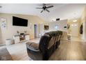 Cozy living room with a ceiling fan, entertainment center and open floor plan at 7319 Jackie Ct, Indianapolis, IN 46221
