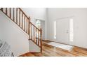 Bright foyer with hardwood floors, stairs and a front door with sidelight windows at 734 Richland Way, Westfield, IN 46074