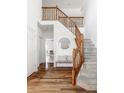 Spacious foyer with hardwood floors, staircase with wood banister, and a seating area at 734 Richland Way, Westfield, IN 46074