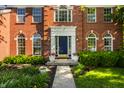 Close-up of the home's front door with lovely landscaping, plants and brick facade at 734 Richland Way, Westfield, IN 46074