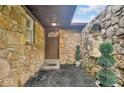 Close up of the stone facade of the home and covered front entrance at 8102 Sycamore Springs Trl, Indianapolis, IN 46239