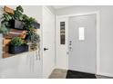Bright entryway featuring neutral walls, a decorative plant, and a white front door at 9002 Walton St, Indianapolis, IN 46231