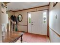 Inviting entryway with wood trim, a classic mirror, and a bright front door with sidelights at 1004 Nevelle Ln, Carmel, IN 46032