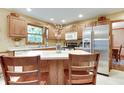 Bright kitchen with stainless steel appliances, a center island with seating, and plenty of counter space at 1004 Nevelle Ln, Carmel, IN 46032