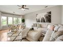 Living room features hardwood floors, neutral paint, large windows, and an eye catching modern rug at 11040 Brave Ct, Indianapolis, IN 46236