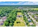Expansive aerial view of a suburban community showcasing the pool and tree-lined surroundings at 11575 Freeport Dr, Carmel, IN 46032