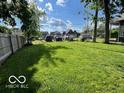 Large grassy backyard perfect for recreation and outdoor activities surrounded by trees at 1304 Franklin St, Columbus, IN 47201