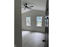 Bright, white bedroom with two windows, vaulted ceiling, ceiling fan and light gray flooring at 1318 Hoyt Ave, Indianapolis, IN 46203