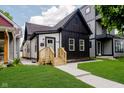 Stylish renovated home with modern black and white exterior, updated facade, and well-manicured lawn at 1318 Hoyt Ave, Indianapolis, IN 46203