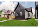 Beautiful renovated home with green lawn, sidewalk, and modern black and white exterior at 1318 Hoyt Ave, Indianapolis, IN 46203