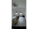 A spacious living room is shown, with new flooring, a ceiling fan, and light-filled windows at 1318 Hoyt Ave, Indianapolis, IN 46203