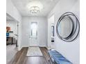 Inviting foyer with hardwood floors, a stylish mirror, and a view into adjacent rooms at 14458 Carlow Run, Carmel, IN 46074