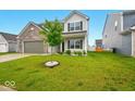 Shot of the front exterior with well kept lawn, landscaping and manicured tree at 1454 Silver Pine Ln, Sheridan, IN 46069